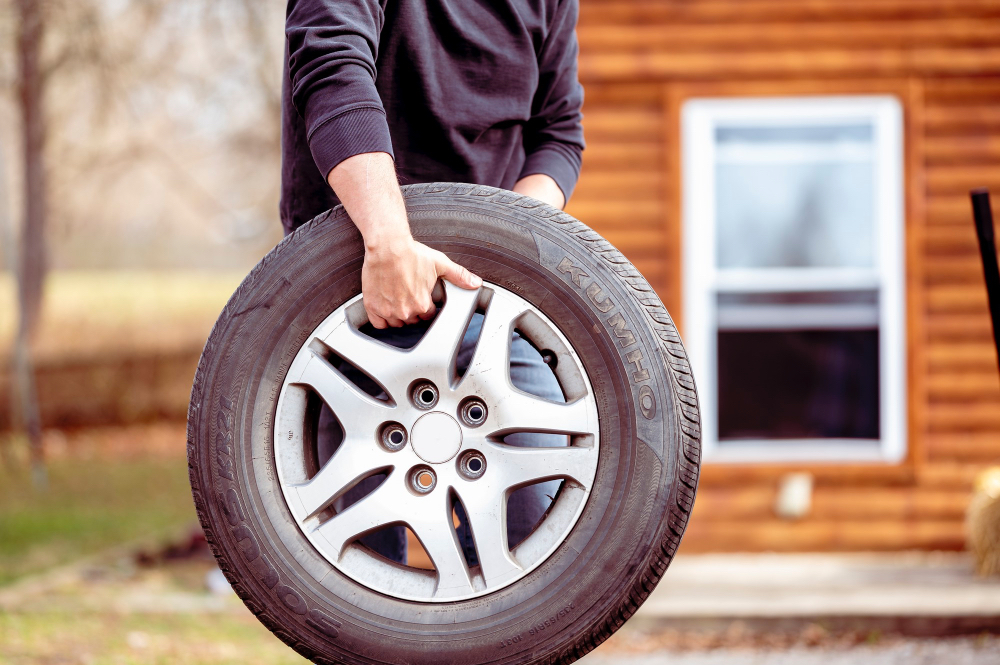 Man with tyre in his hands
